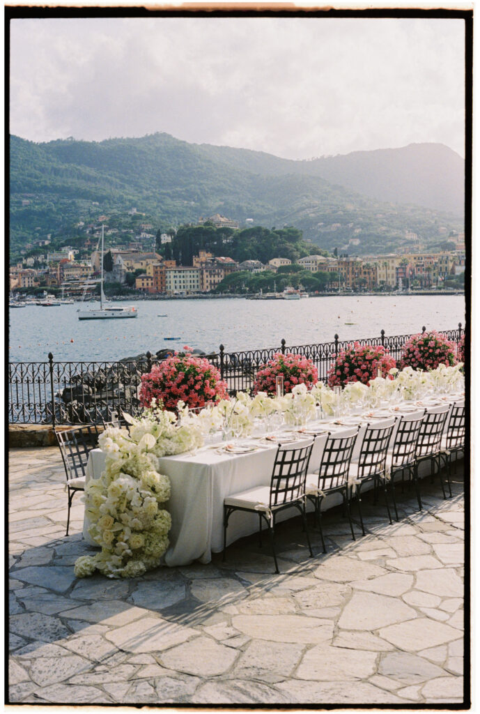 Long reception table with white florals overlooking the Santa Margherita Ligure harbor, Imperiale Palace wedding reception